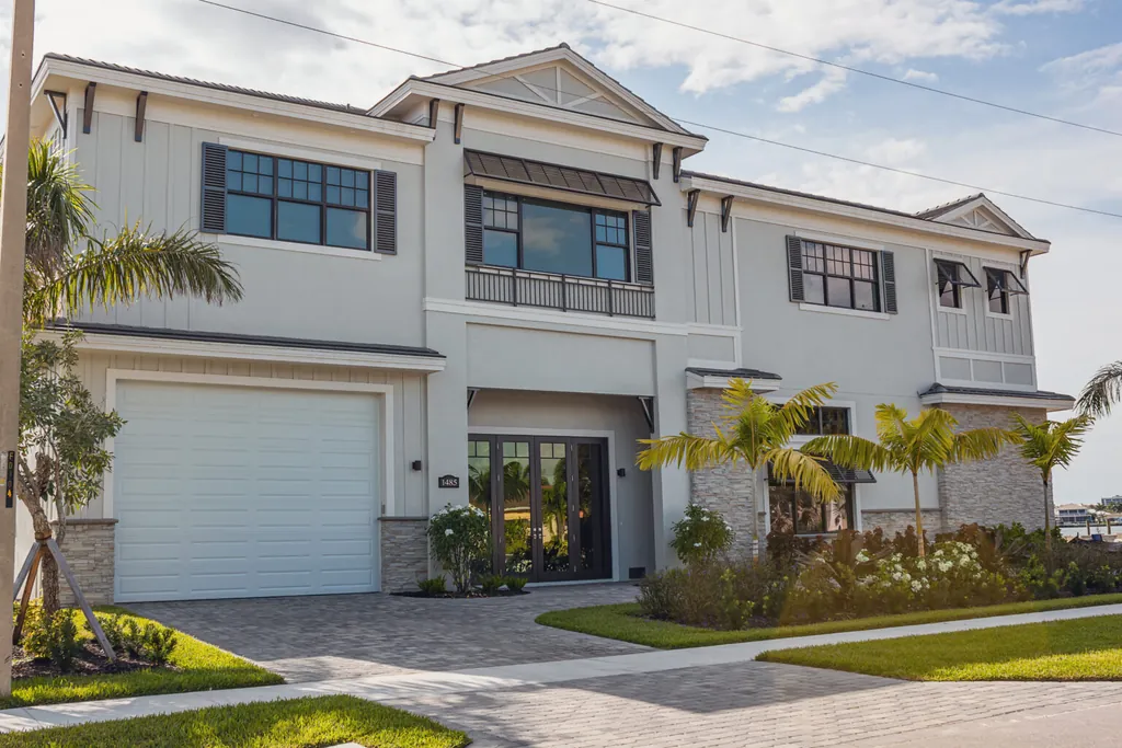 Coastal white craftsman home with white sectional garage door