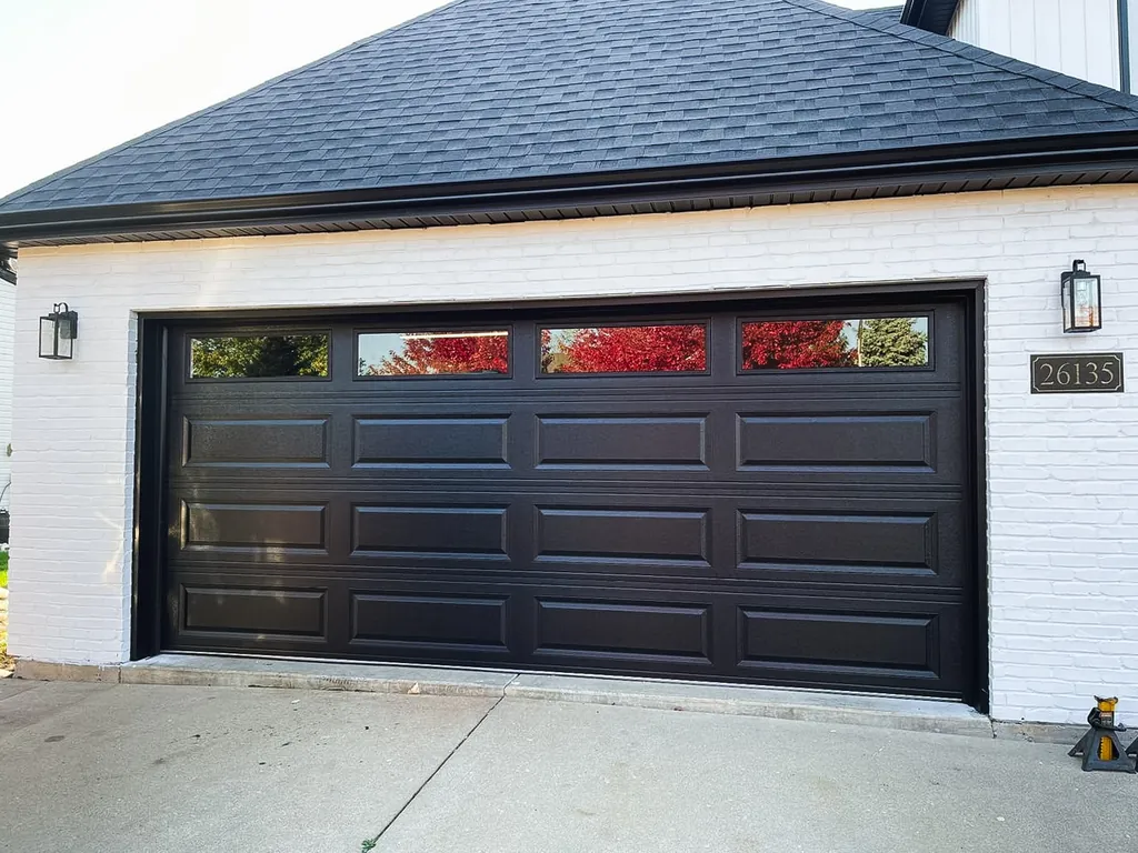 Coastal Georgia home with dark raised-panel garage door installed by Garage Door of Brunswick