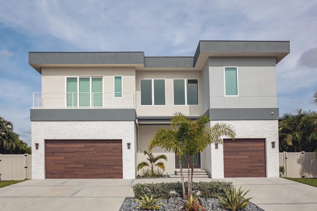 Modern coastal home with dark oak wood-look garage door